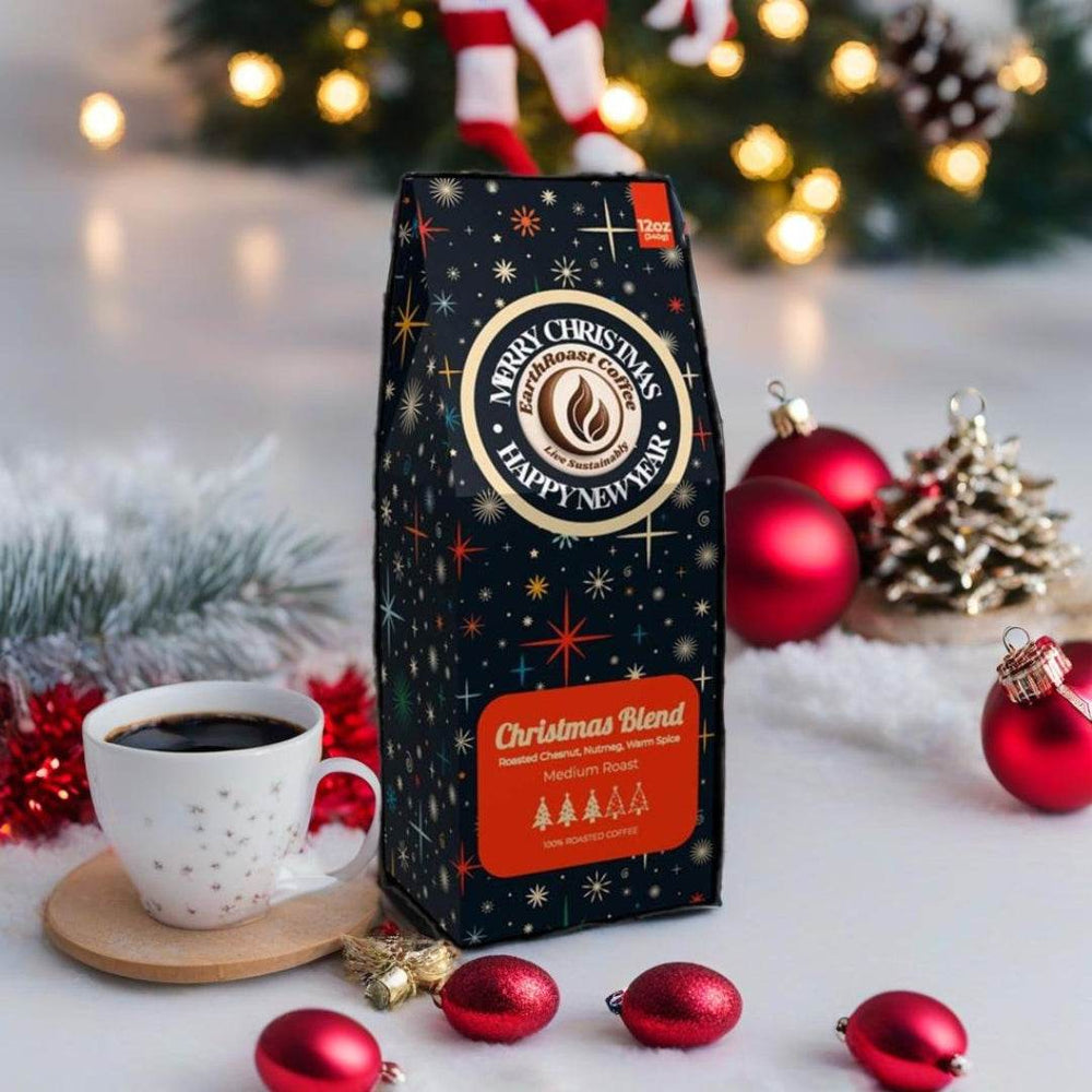 Front view of EarthRoast Coffee's Christmas Blend Specialty Coffee box. This medium roast features festive flavors of roasted chestnut, nutmeg, and warm spice. Decorated with holiday-themed designs and surrounded by Christmas ornaments, this sustainably sourced, organic specialty coffee is perfect for the season.