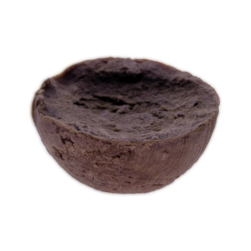 African Black Soap Shampoo Bar with tea tree oil, natural and pH-neutral, in half-sphere shape.