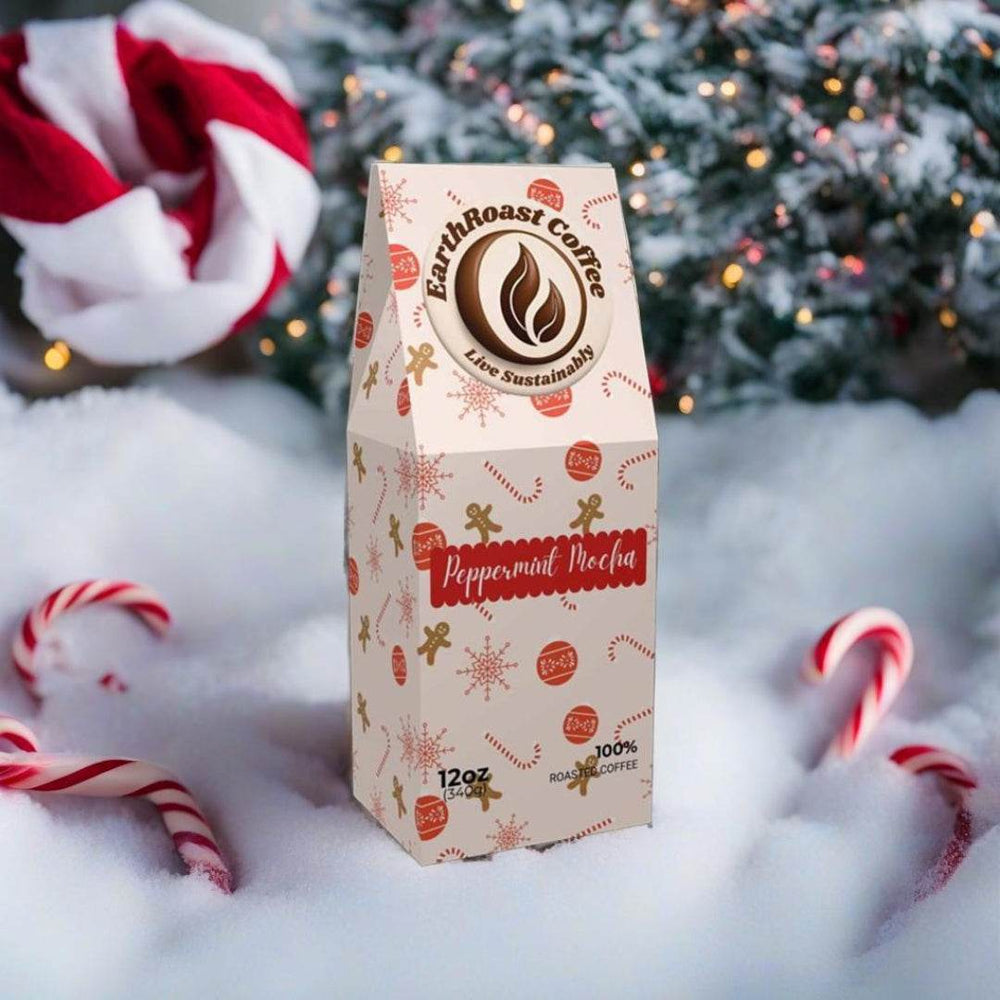 Front view of EarthRoast Coffee's Peppermint Mocha Specialty Coffee bag. Decorated with festive holiday designs featuring candy canes, gingerbread men, and snowflakes, set in a snowy background with Christmas trees and candy canes, highlighting the organic, sustainably sourced holiday flavor.