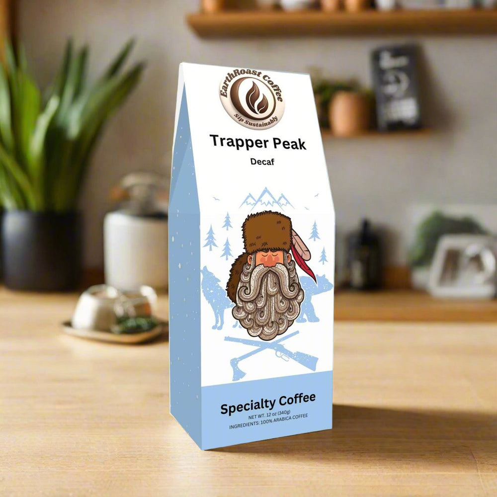 EarthRoast Coffee Trapper Peak Decaf, a specialty coffee offering rich flavor without the buzz. Sustainably sourced and organic, packaged in a 12 oz recyclable bag with a charming outdoorsman-themed design, perfect for environmentally conscious coffee lovers.